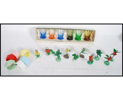 A collection of vintage / retro kitsch to include a set of six multi coloured napkin rings, a set of ten miniature&nbsp; bons