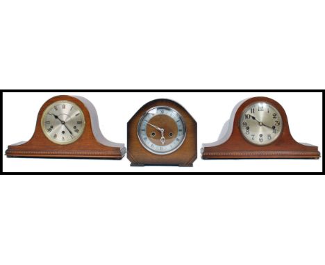 A group of vintage 20th century wooden cased mantle clocks to include two Napoleon hat clocks along with another clock. Highe