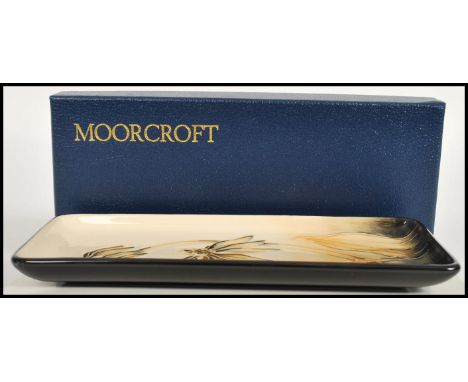 A Moorcroft ceramic pin tray of rectangular form tube lined decorated with flowers complete in original box C2001 mushroom ma