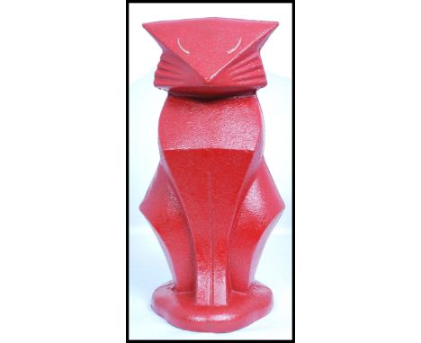 A vintage Art Deco style cast metal door stop in the form of a stylised Art Deco seated cat, finished in red paint. Measures 