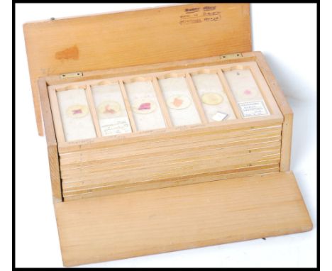 A good collection of vintage 20th century Scientific microscope sample slides contained within a wooden slide box.