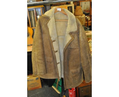 A vintage 20th century hip length gents sheepskin coat approximately size 46, slightly torn to one sleeve