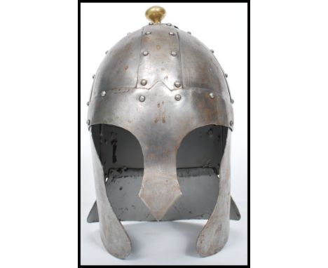 A reproduction Medieval 16th century style helmet of cast metal construction having a hammered and nailed appearance.