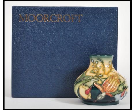 A Moorcroft ceramic vase tube lined decorated with flowers complete in original box C2001 sheild marks and signatures to vers