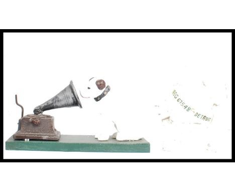 A vintage style cast iron point of sale advertising figurine of Nipper the HMV gramophone dog having painted detailing togeth