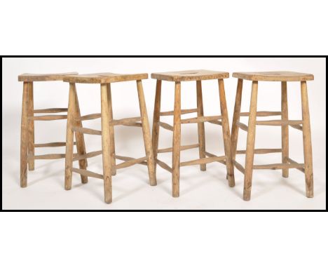 A set of 4 retro 20th century Industrial lab - laboratory stools raised on turned legs with peripheral stretchers, panel seat