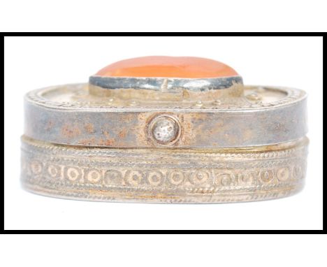 A vintage Kazakhstan silver gilt and Carnelian snuff box from Russian central Asia, fitted with a hinged gilt decorated lid, 