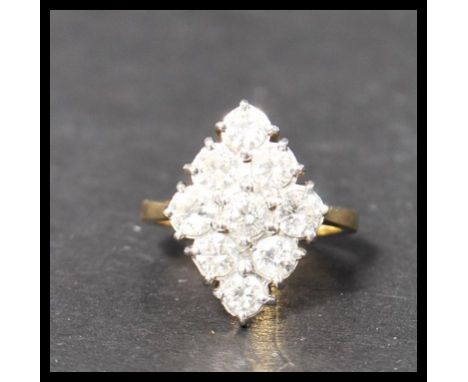 A hallmarked 18ct gold and diamond ring. The nine round cut diamond stones being approx 20pnts and arranged in a diamond form