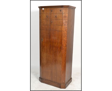 A vintage 1930s Art Deco oak bachelors single wardrobe, having geometric and stud finish to the door, the door opening to rev