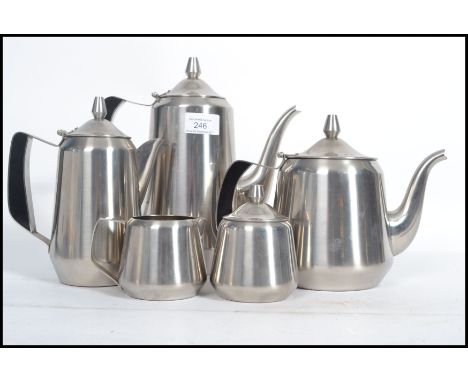 A vintage retro mid 20th century space age steel five person tea service.. Each piece having a tapering conical body with sha