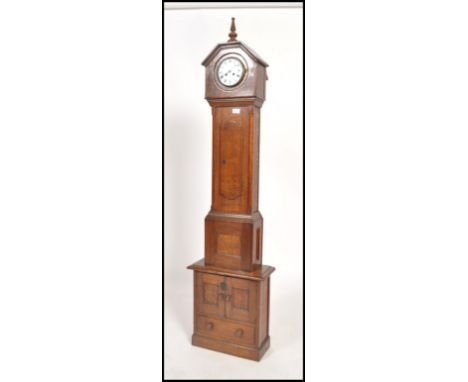 A 19th century oak cased continental&nbsp; grandmother clock raised on a later built cupboard plinth base. The clock having a