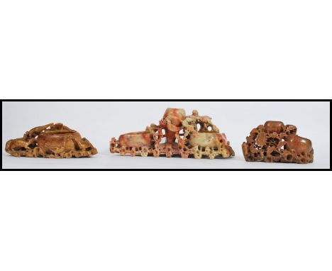 A collection of 3 vintage Chinese soapstone brush pots, each of varying design being well carved with foliate, lizards etc