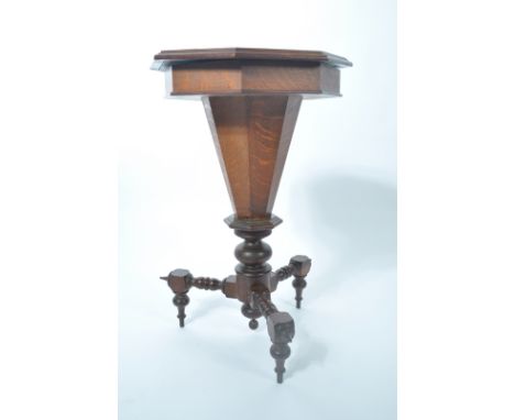 A 19th century Victorian oak trumpet shaped work box - games table. The table raised on angled bobbin legs supporting a turne