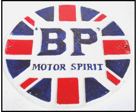 A vintage style cast metal point of sale advertising wall plaque for BP / British Petroleum. The circular plaque in the form 