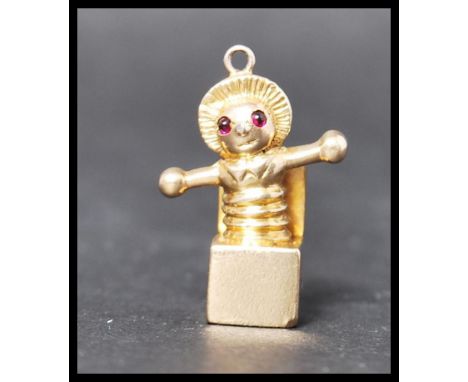A 9ct gold Jack In The Box charm having ruby stone eyes. Unmarked but tests as 9ct gold, eyes test as rubies. Weighs 7 grams.