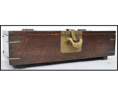 A vintage 20th century Oriental Chinese wooden box having brass hinge and lock. The lid opening to reveal a Chinese character