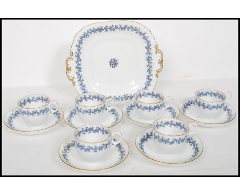 A 20th century vintage Davenport ceramic six person part tea service consisting of cups, saucers, side plates and large cake 