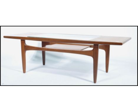 G-Plan - A retro 1970's teak wood long John coffee table with inset glass top with exposed panel under tier / magazine rack. 