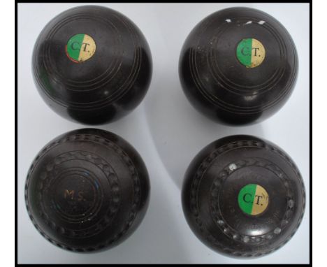 A set of four vintage&nbsp;20th century Lignum Vitae lawn bowls, applied makers plaque to all.