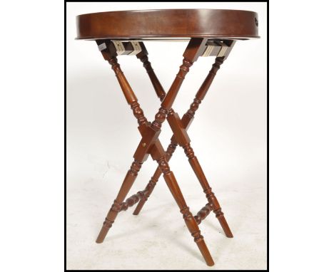 A contemporary antique Georgian style revival butlers tray and stand. The coaching stand of bobbin form with oval tray top bu