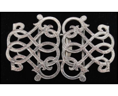 A pair of silver hallmarked scroll work Nurses buckles, Birmingham assay mark, date letter K ( 1959 ) and makers mark for LW.
