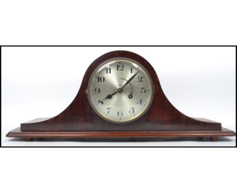 An Edwardian mahogany inlaid napoleons hat mantel clock having silvered dial with brass inset movement striking on a gong. Me