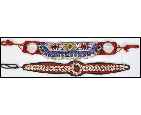 Two vintage South American vintage 20th century bead and shell worked work belts, one with oval inset mirror glass, both bein