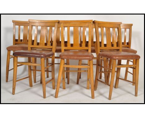 A set of 7 20th century beech wood chapel chairs. Each with turned legs united by stretchers, upholstered seats with book tro