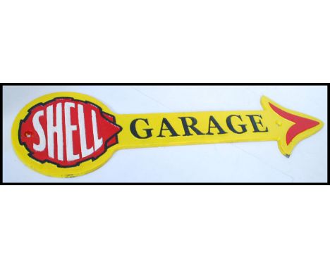 A vintage style painted cast iron advertising point of sale garage sign for Shell in the form of an arrow. Measures: 42cm wid