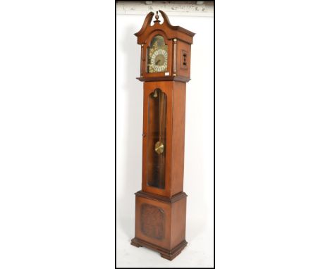 A 20th century mahogany Tempus Fugit longcase clock with silvered dial marked for ECS Westminster Germany. The trunk window w