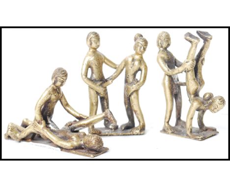 A group of three vintage 20th century Indian Kamasutra cast brass figurines of couples in various sexual positions.&nbsp;Meas