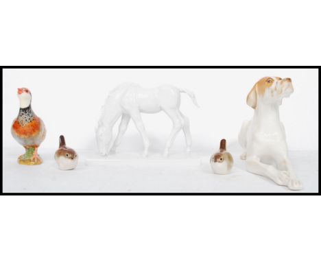 A collection of ceramic figurines to include a pair of Lomonosov / USSR Wrens, a large hound and a Beswick Pheasant and a Bla