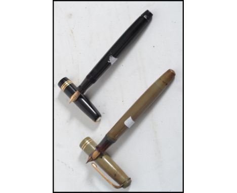 Two vintage 20th century fountain pens. One being a Parker pen with a 14ct gold nib and Swan pen in black.