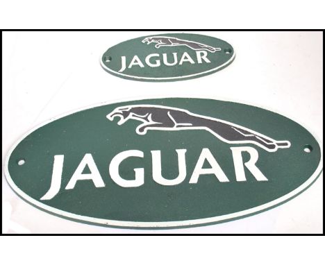 A pair of vintage graduating style cast metal point of sale advertising garage wall plaques for Jaguar motor cars featuring t