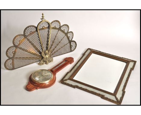A 20th century peacock folding brass firescreen with finial top together with a Shortland banjo barometer with silvered dial 