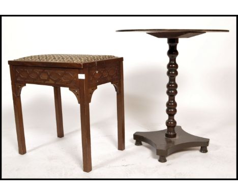 An Edwardian piano stool with hinged led raised on square legs with blind fret worked detailing together with an early 20th c