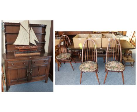 An Ercol oak dining suite comprising refectory style table, 180cm long, six stick-back chairs and Welsh dresser, 123cm wide (