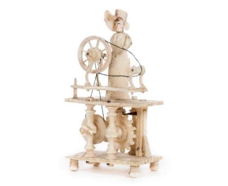 *Automaton.  A 19th century bone prisoner of war automaton,  carved as woman operating a spinning wheel, 10cm high (some dama