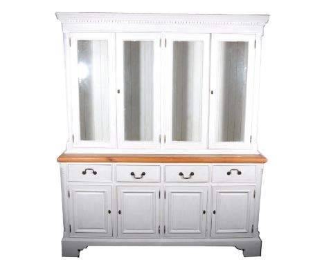 A contemporary part painted pine dresser, the top section with four glazed cupboards, above a natural wood top with moulded e