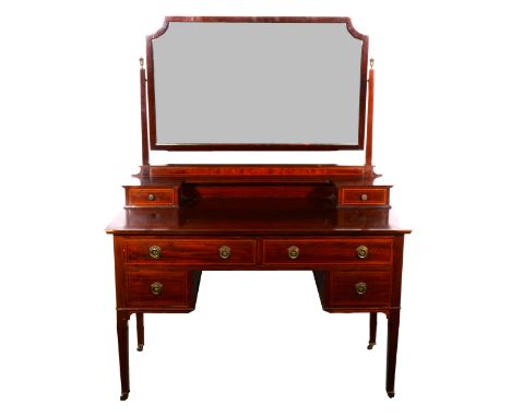 An Edwardian mahogany and burr walnut dressing table, shaped rectangular bevelled plate, raised on tapering support above tri