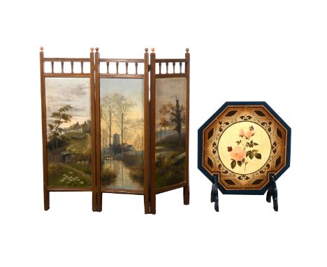 A stained wood three-fold fire screen, painted panels of landscape scenes, one initialled L.G., height 79cm; and an octagonal