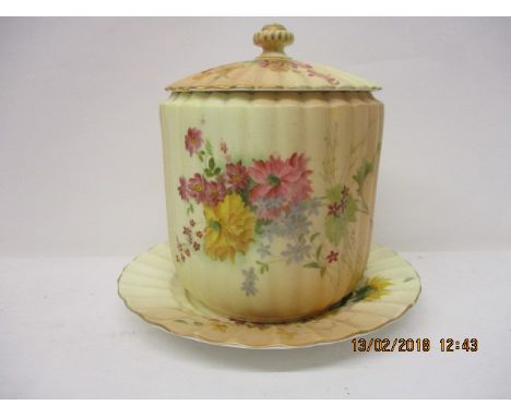 A Royal Worcester blush ivory glazed biscuit barrel and cover on a dished stand, with fluted, reeded and floral sprig decorat