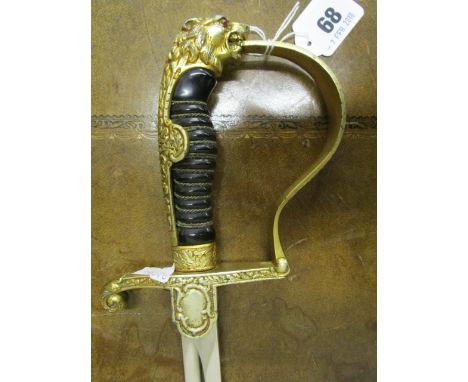 A German army lion head dress sword, the head with inset red jewelled eyes, with wrapped Bakelite grip, eagle and Swastika on