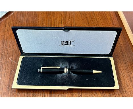 A Mont Blanc Meisterstuck gold-coated ballpoint or rollerball pen with case, black with golden accents.