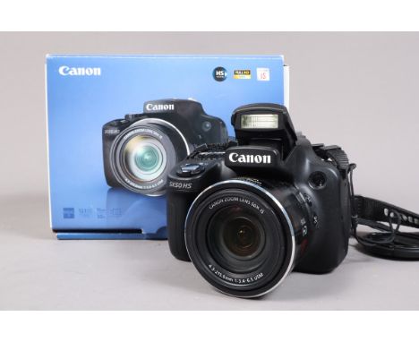 A Canon Powershot SX50 HS Digital Bridge Camera, serial no 613031015189, powers up, takes a picture, no card, not otherwise t