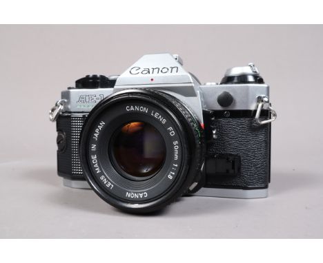 A Canon AE-1 Program SLR Camera, serail no 4150104, shutter working, meter responsive, body G-VG, with 50mm f/1.8 FD lens, ba
