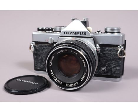 An Olympus OM 1 MD SLR Camera, seial no 574286, shutter working, meter responsive, self timer working, body G-VG, with F Zuik