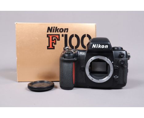 A Nikon F100 SLR Camera Body, powers up, shutter working, body G, light tackyness to back, in maker's box, with manual 