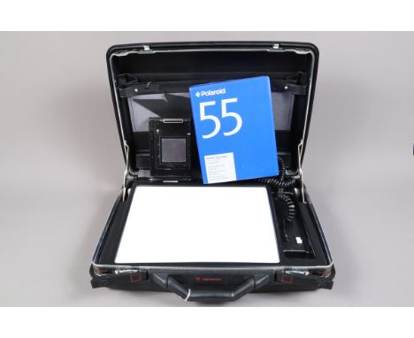 A Hasselblad 100 Polaroid Back and a Lightbox, a Polaroid back for Hasselblad 500CM, together with a Polaroid 55 film pack fo
