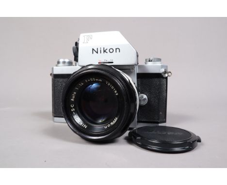 A Nikon F Photomic SLR Camera, serial no 6988277, shutter working, self timer working,body G, light scratches to base, with N